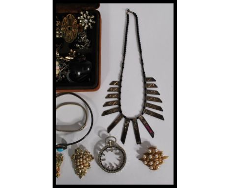 A collection of vintage 20th century costume jewellery to include a sterling silver and turquoise rigid necklace , deer foot 