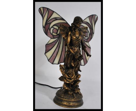 A good quality 20th century table lamp in the form of a fairy with decorative wings in a Tiffany style.