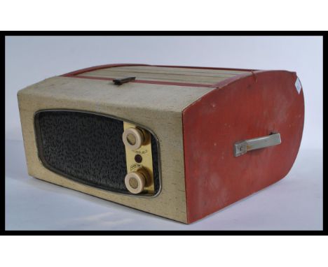 A mid century Monarch two tone portable record player in red and white colourway with unusual tambour rolling top complete wi