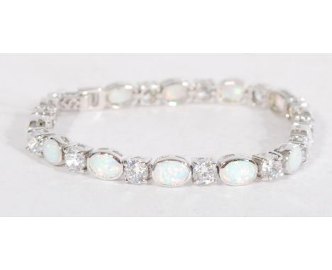 A sterling silver and opal panel tennis bracelet having a fold over clasp.