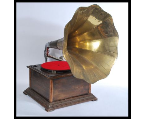 A vintage oak cased table top gramaphone having a fabulous brass Morning Glory horn with oak cased record player with a label