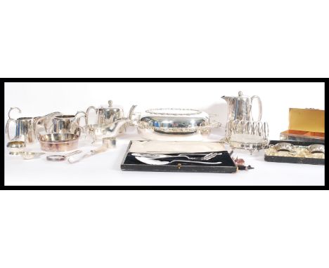 A large collection of silver plated wares to include flatware, spoons, knives, sifting spoons, enamel spoons, toast racks, te