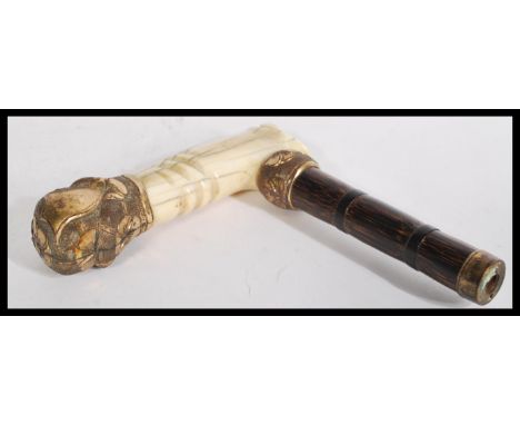 An early 20th century 14ct gold plated walking stick handle having a bamboo shaft with 14ct gold plate mounts.