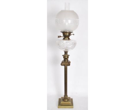 A 19th century Victorian tall oil lamp raised on a stepped square base with classical column cut glass well and twin pusher b
