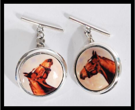 A pair of equestrian horse racing related sterling silver and enamel cufflinks cuff links having pictorial plaques of horses.