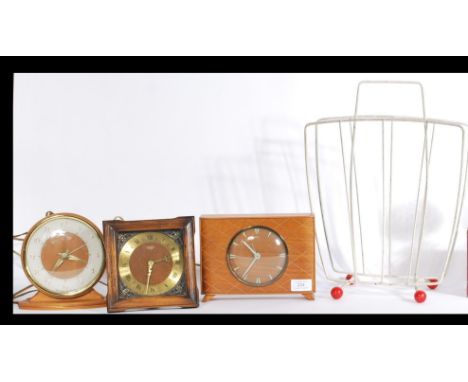 A collection three vintage mid 20th Century electric clocks to include Smiths together with a retro magazine rack. Highest me