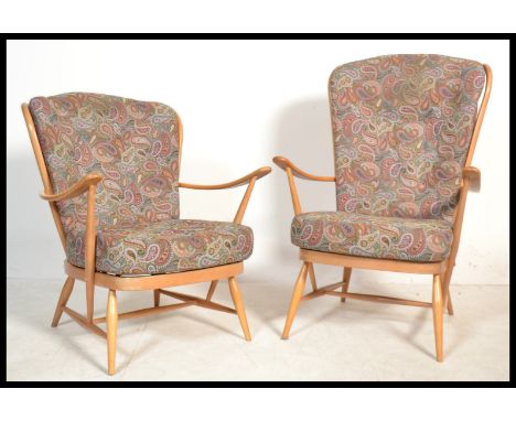A pair of mid 20th Century Ercol light beech and elm spindle back Windsor his and hers matching armchairs with propeller arm 