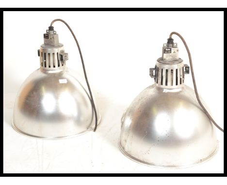 A pair of vintage 20th century industrial factory ceiling lights having conical pendant shades.&nbsp;Measures: 50cm high x 40