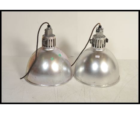 A pair of vintage 20th century industrial factory ceiling lights having conical pendant shades.&nbsp;Measures: 50cm high x 40