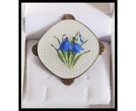 A vintage 20th century sterling silver Danish Guilloche enamel brooch&nbsp; having a white enamel ground with blue enamel flo