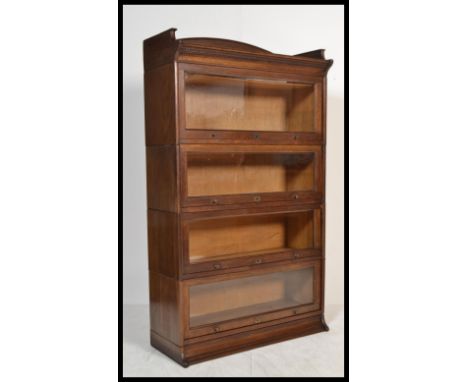 An Edwardian / early 20th century oak Lebus stacking lawyers bookcase cabinet in the manner of Globe Wernick, having four sec