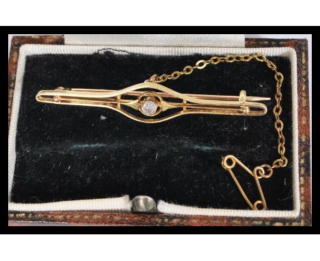 A vintage 20th century 9ct gold and single stone diamond bar brooch complete with safety chain in presentation box