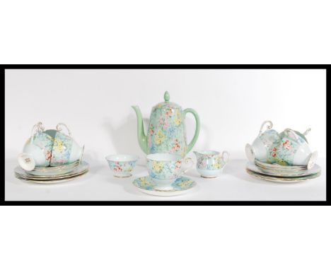 A vintage early 20th century art deco tea service by Shelley. The tea set in the ' Melody ' Pattern consisting of seven cup s