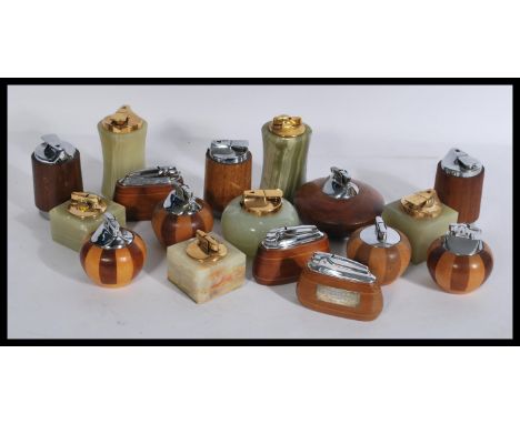 A collection of vintage Ronson table top lighters some in alabaster mounts and the others in wooden mounts. Please see images