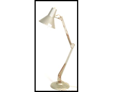 A mid century retro Industrial anglepoise lamp in silvered metal being raised on circular base with pendant shade and angular