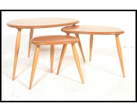 A vintage / retro set of Ercol light&nbsp; beech and elm retro pebble nest of tables, shape 354. Each raised on turned legs h