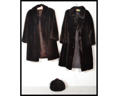 Two vintage 20th Century simulated ladies full length fur coats together with a mink tail hat and a sheepskin hat.