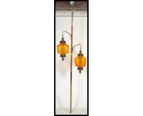 A stunning twin branched floor to ceiling standard lamp, fitted with two amber glass pineapple shaped shades connected to an 