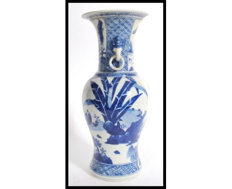 A 19th century Chinese blue and white vase having a bulbous body with tapered neck flared rim and ceramic drop handles. Hand 