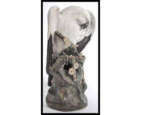 A large Japanese ceramic sculpture study modelled as a Sea Eagle, sat atop a naturalistic perch grooming itself. Measures 45 