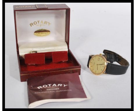 A vintage 20th century 9ct gold Rotary watch having a champagne dial with baton numerals and faceted hands. Date aperture to 