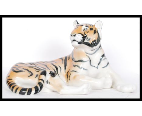 A large ceramic figure modelled as a tiger, marked USSR underneath in a reclined position. Measures 30 cm wide.