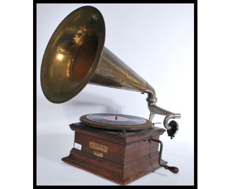 A vintage early 20th Century gramophone with brass horn, with label to front for The Gramophone and Typewriter, 21 City Road,