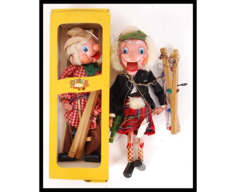 An original vintage boxed Pelham Puppet along with a loose Pelham Puppet depicting a Scotsman in a kilt.