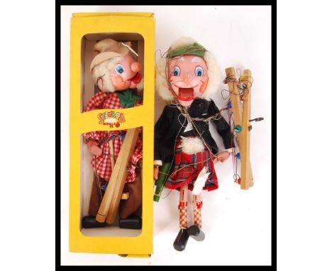 An original vintage boxed Pelham Puppet along with a loose Pelham Puppet depicting a Scotsman in a kilt.