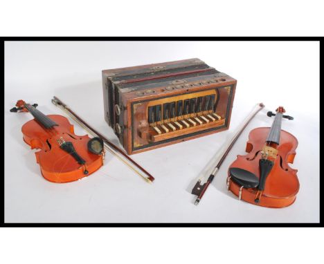 Two vintage cased violin musical instruments by Skylark along with a vintage 20th century piano accordion.
