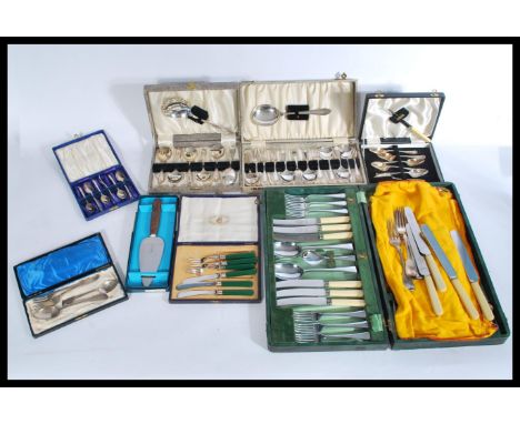 A group of cased silver plated flatware to include animal finial cutlery spoons , knives etc. All in fitted cases.