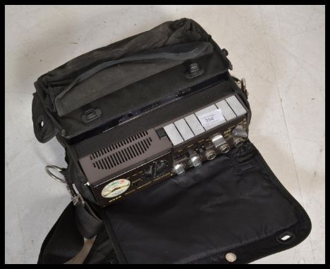 A vintage retro portable reporters reel to reel tape recorder by UHER model Heads 1426 in original carry case.