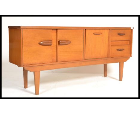 A vintage teak wood sideboard with 2 doors to left, drop down door in middle and 2 drawers to right.&nbsp;Measures: 76cm high