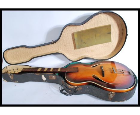 A vintage 20th century The Michigan six string acoustic guitar having a shaped hollow body complete in hard guitar case. Meas