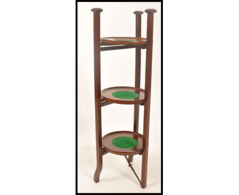 An Edwardian mahogany inlaid 3 tier baize lined metamorphic cake - plate stand in the manner of Shapland &amp; Petter.  Line 
