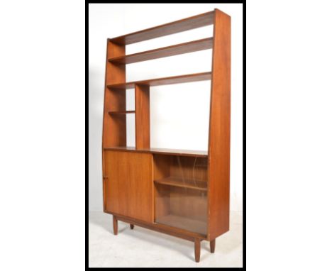 A vintage retro 20th century Danish influence teak room divider having a sliding glass and wooden cupboard unit of tall uprig