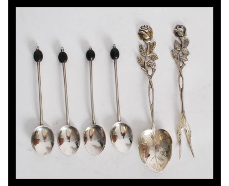 A group of four hallmarked silver coffee bean spoons along with a set pair of pickle fork and spoon stamped 800 with rose flo