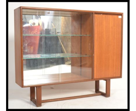 A vintage teak wood display cabinet with glass sliding doors to left and a solid teak door to right.&nbsp;Measures: 95cm high