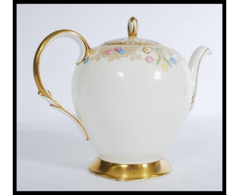 A 20th Century bone China teapot decorated with gilt and floral swags, stamp to base for E. Brain &amp; Co for Foley Bone Chi