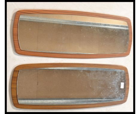 A pair of vintage 20th century Afromosia wood frameless wall mirrors of typical form.&nbsp;Measures: 79cm high x 30cm wide.