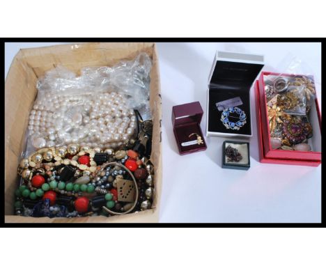 A collection of vintage costume jewellery including bangles , beads , brooches along with a 9ct gold pirate earring skull and