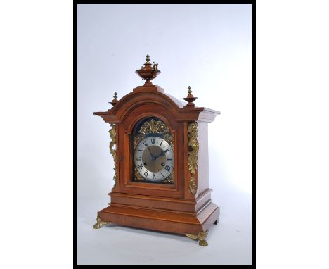 A German Mantel Clock, of architectural form, the eight day movement by Junghans, striking on a gong and chiming on rods, the