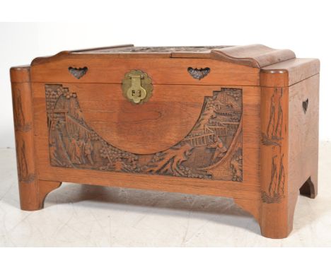 A mid century, circa 1950's camphor wood Chinese trunk / blanket box having panel sides with hinged top, all over carved deta