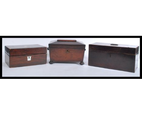 A 19th century Georgian rosewood and brass inlaid ladies workbox. The sarcophagus shaped body with pad feet, hinged top with 