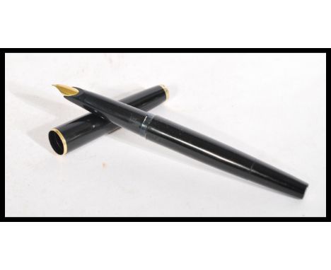 A vintage Mont Blanc fountain pen having black body with white star to lid and end. Gilt metal mounts and nib.