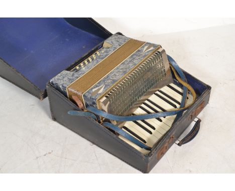 Musical Instruments. A vintage early 20th century Paulo Antonio piano accordion in faux marbled casing and in carrying case.