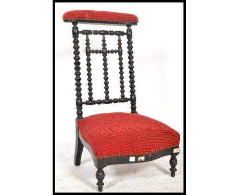 A 19th Century French ebonised and upholstered&nbsp;bobbin turned prie dieu chair, raised on turned supports.&nbsp;Measures: 