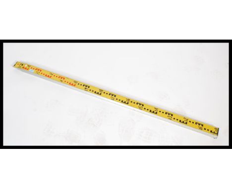 A retro 20th century Industrial scale meter used by engineers - draftsmen. The extending action brushed metal case with yello