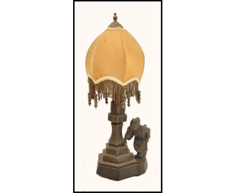 An early 20th century spelter Chinoiserie lamp raised on a stepped hexagonal base with tapered column with spelter figurine o