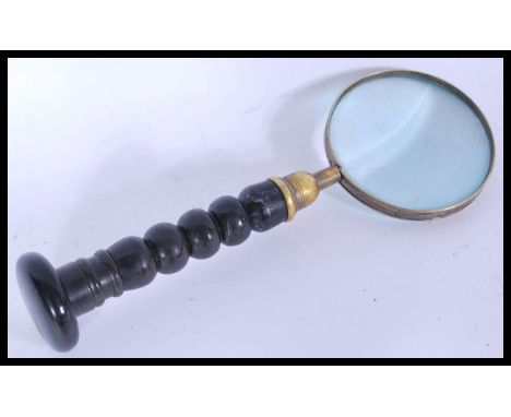 A vintage early 20th century large brass magnifying glass with turned wooden handle. Please see images.
